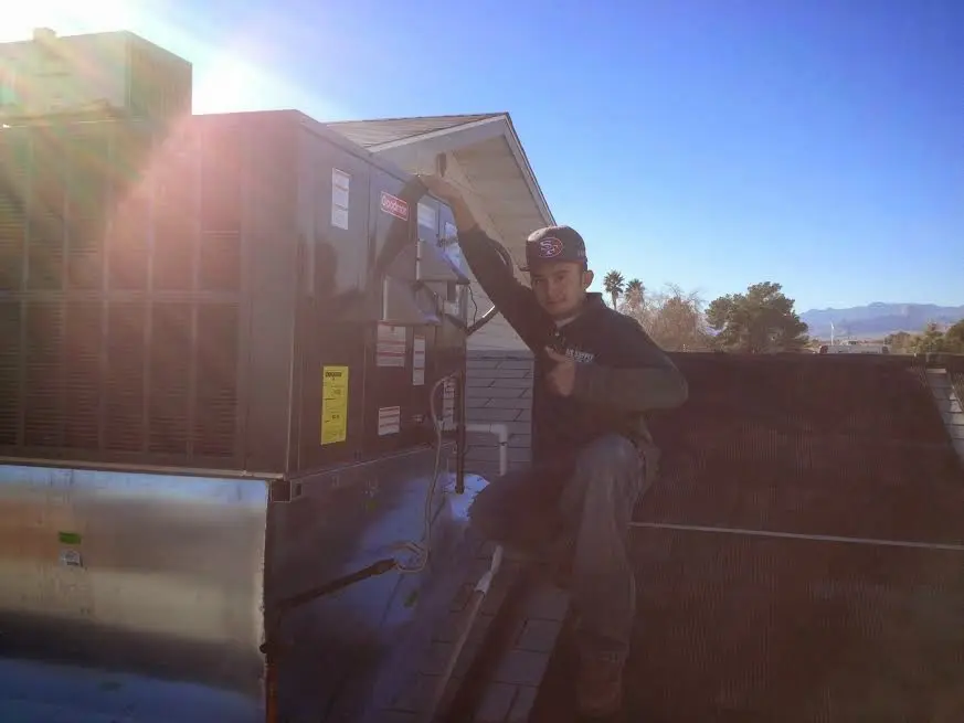 HVAC technician performing AC Tune-Up on a rooftop unit in Mill Valley